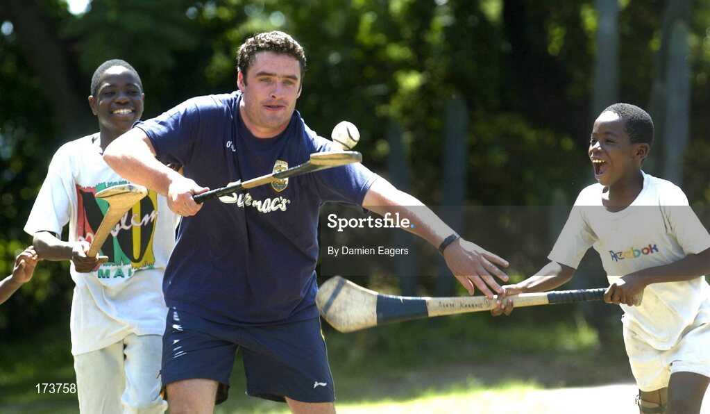25 February 2005; Galway's Alan Kerins plays hurling with local children Namatimbo, left, and Simona. Cheshire home for the physically challenged children, Mongu, Zambia. Picture credit; Damien Eagers / SPORTSFILE