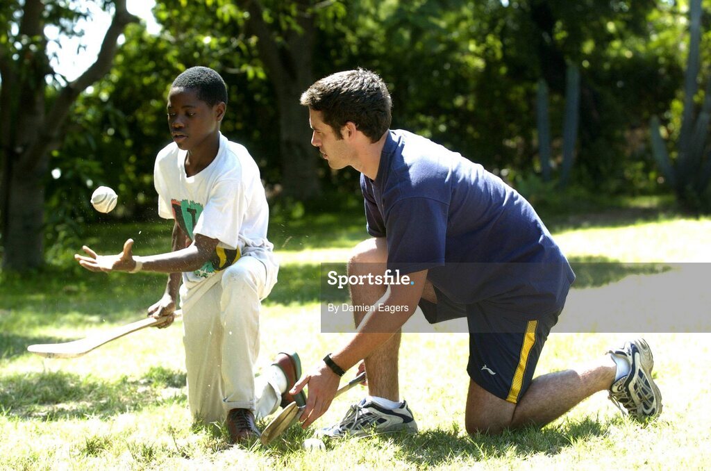 25 February 2005; Galway's Alan Kerins teaches some hurling skills to Namatimbo. Cheshire home for the physically challenged children, Mongu, Zambia. Picture credit; Damien Eagers / SPORTSFILE