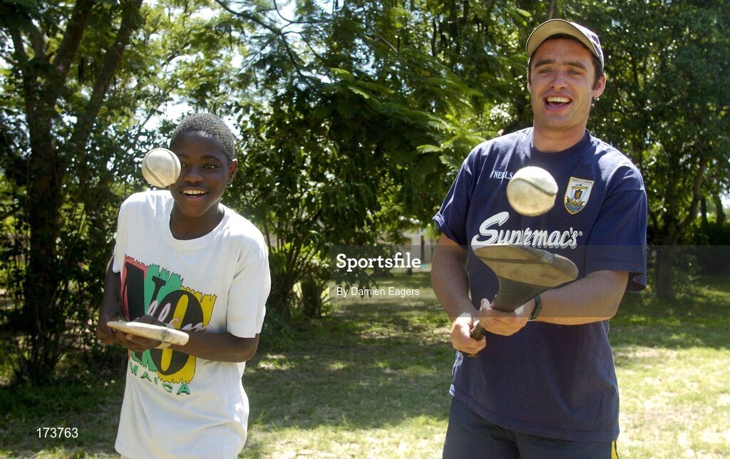 25 February 2005; Galway's Alan Kerins teaches some hurling skills to local boy Namatimbo. Cheshire home for the physically challenged children, Mongu, Zambia. Picture credit; Damien Eagers / SPORTSFILE