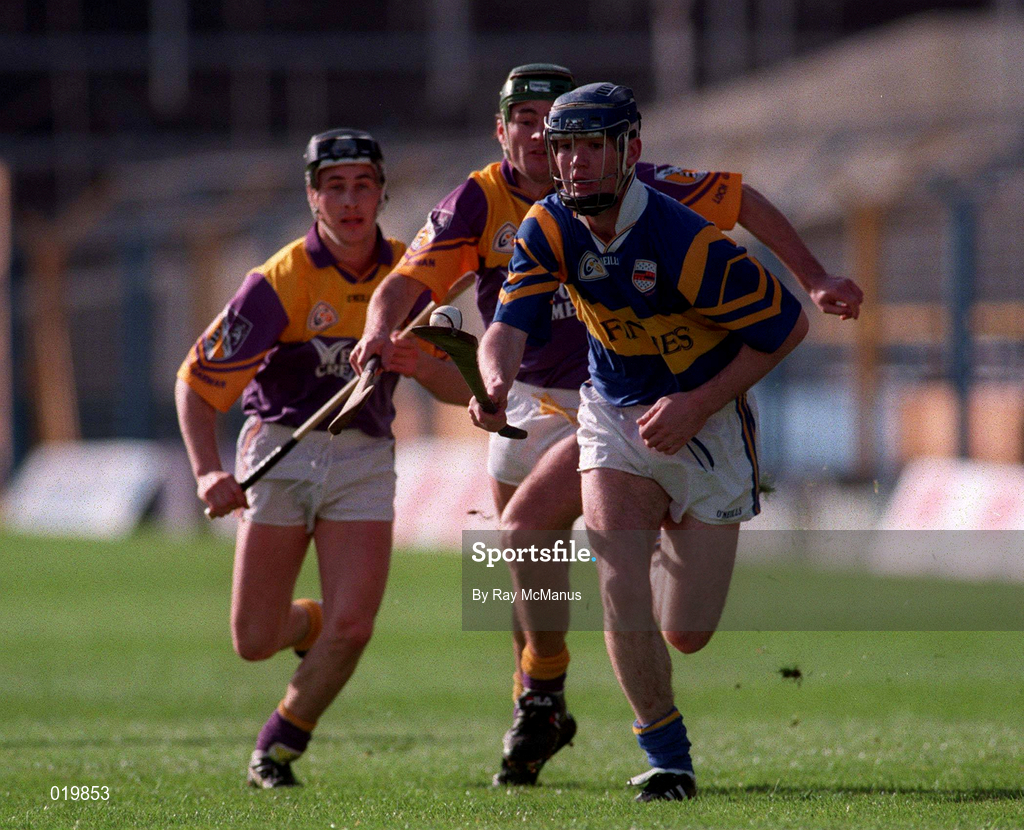 21 March 1999; Eddie Tucker of Tipperary in action against Declan Ruth and Rory McCarthy of Wexford during the Church and General National Hurling League Division 1B match between Tipperary and Wexford at Semple Stadium in Thurles, Tipperary. Photo by Ray McManus/Sportsfile
