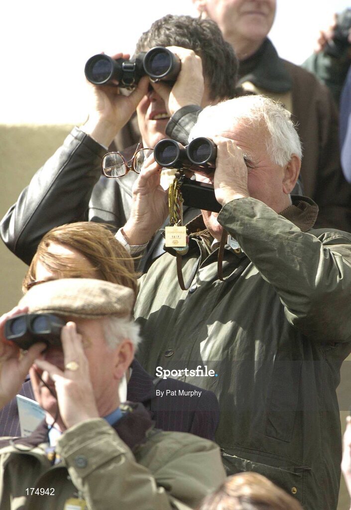 28 April 2005; Racegoers keep an eye on the field. KFM Hunters Steeplechase (Bishopscourt Cup). Punchestown Racecourse, Co. Kildare. Picture credit; Pat Murphy / SPORTSFILE