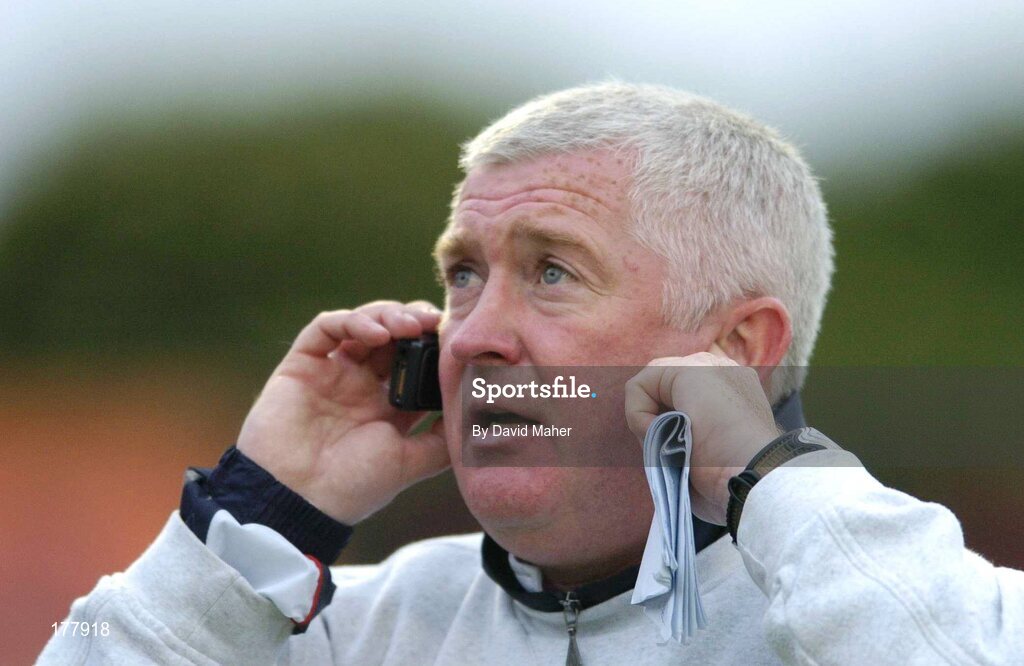 27 May 2005; Eamon Collins, Shelbourne assistant manager, receives instructions by mobile phone from his manager Pat Fenlon in the stand. eircom League, Premier Division, Bohemians v Shelbourne, Dalymount Park, Dublin. Picture credit; David Maher / SPORTSFILE