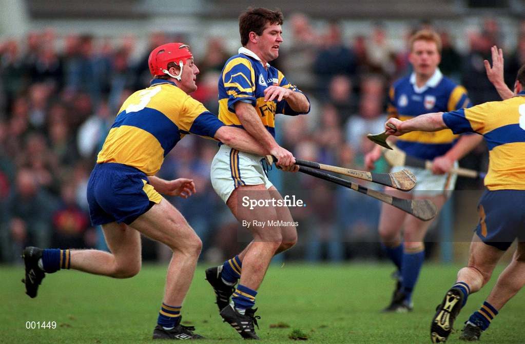 10 May 1997; Michael Cleary of Tipperary in action against Brian Lohan, left, with Ollie Baker of Clare during the National Hurling League Division 1 match between Clare and Tipperary at Cusack Park in Ennis, Clare. Photo by Ray McManus/Sportsfile