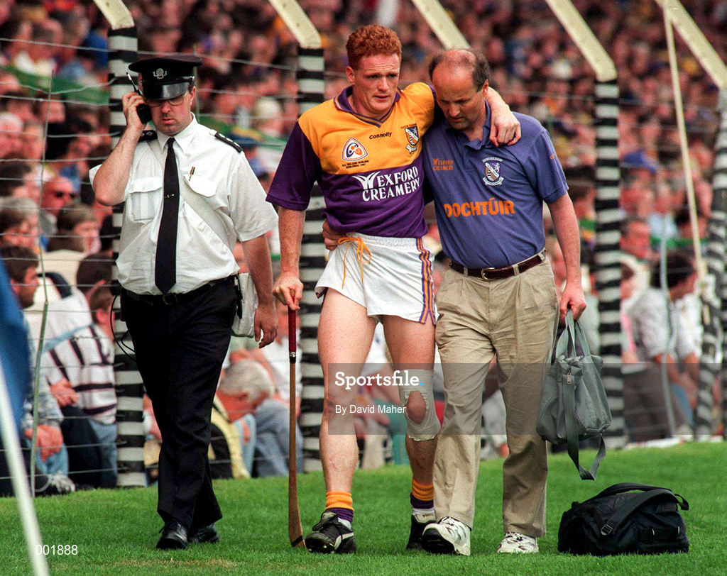 17 August 1997; Rod Guiney Wexford is helped off the pitch by the Wexford team doctor during the GAA All-Ireland Senior Hurling Championship Semi-Final match between Tipperary and Wexford at Croke Park in Dublin. Photo by David Maher/Sportsfile