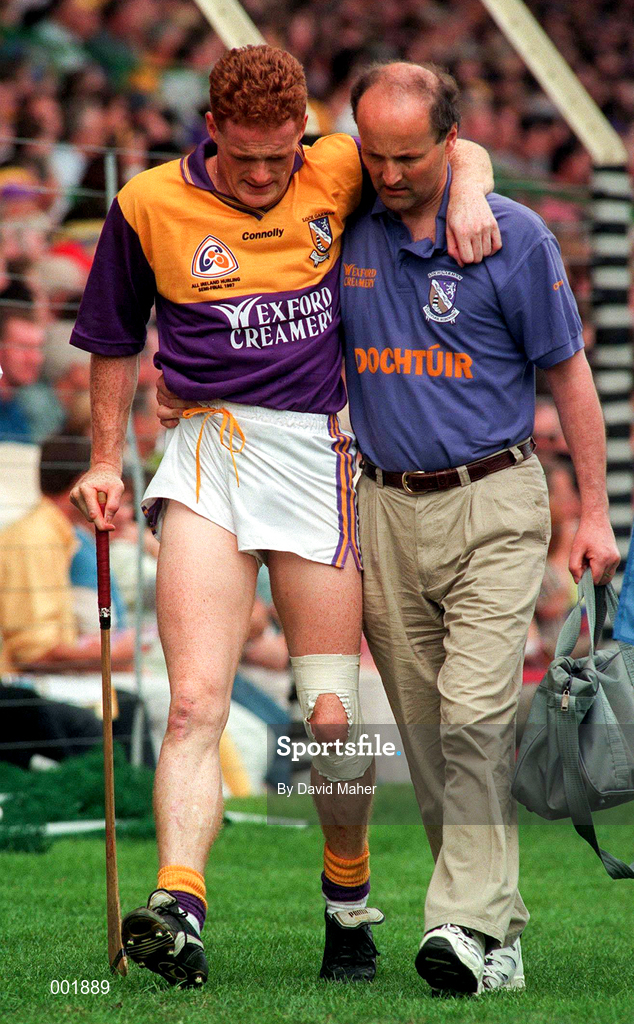17 August 1997; Rod Guiney Wexford is helped off the pitch by the Wexford team doctor during the GAA All-Ireland Senior Hurling Championship Semi-Final match between Tipperary and Wexford at Croke Park in Dublin. Photo by David Maher/Sportsfile