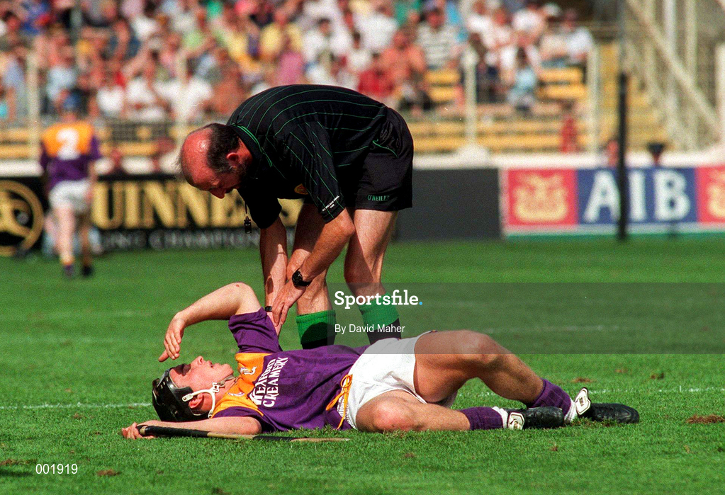 17 August 1997; Referee Joe O'Leary checks up on Rory McCarthy of Wexford during the GAA All-Ireland Senior Hurling Championship Semi-Final match between Tipperary and Wexford at Croke Park in Dublin. Photo by David Maher/Sportsfile