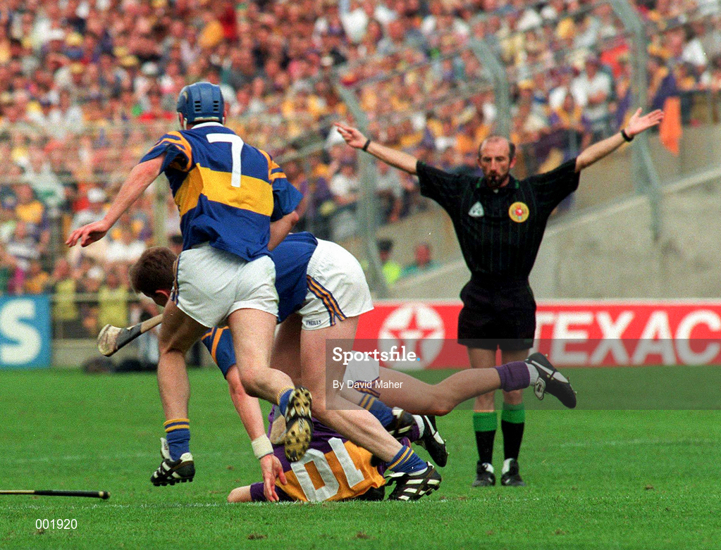 17 August 1997; Referee Joe O'Leary waves play on after a tackle on Rory McCarthy of Wexford during the GAA All-Ireland Senior Hurling Championship Semi-Final match between Tipperary and Wexford at Croke Park in Dublin. Photo by David Maher/Sportsfile