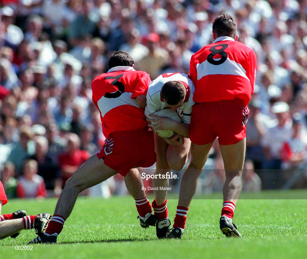 29 June 1997; Stephen Lawn of Tyrone in action against David O'Neill and Anthony Tohill of Derry during the Ulster GAA Football Senior Championship Semi-Final match between Tyrone and Derry at St. Tiernach's Park in Clones, Monaghan. Photo by David Maher/Sportsfile