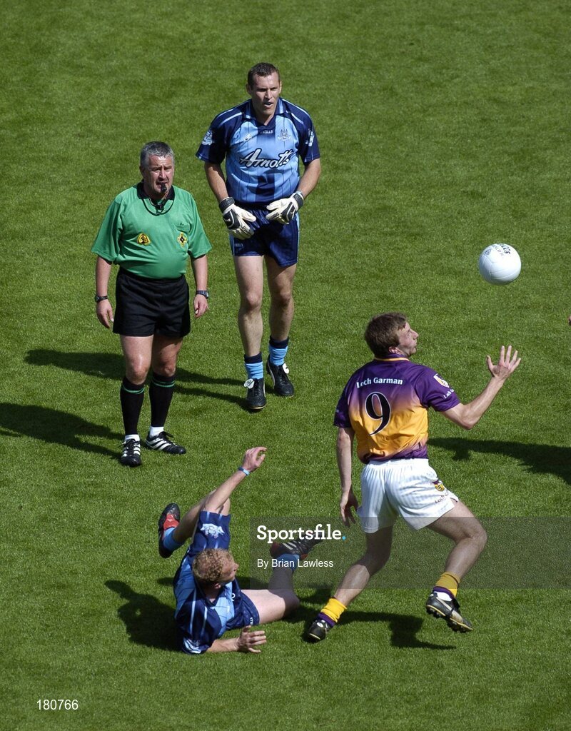 19 June 2005; David Fogarty, Wexford, in action against Shane Ryan, Dublin, as referee Brian Crowe and Dublin's Ciaran Whelan look on. Bank of Ireland Leinster Senior Football Championship Semi-Final, Dublin v Wexford, Croke Park, Dublin. Picture credit; Brian Lawless / SPORTSFILE