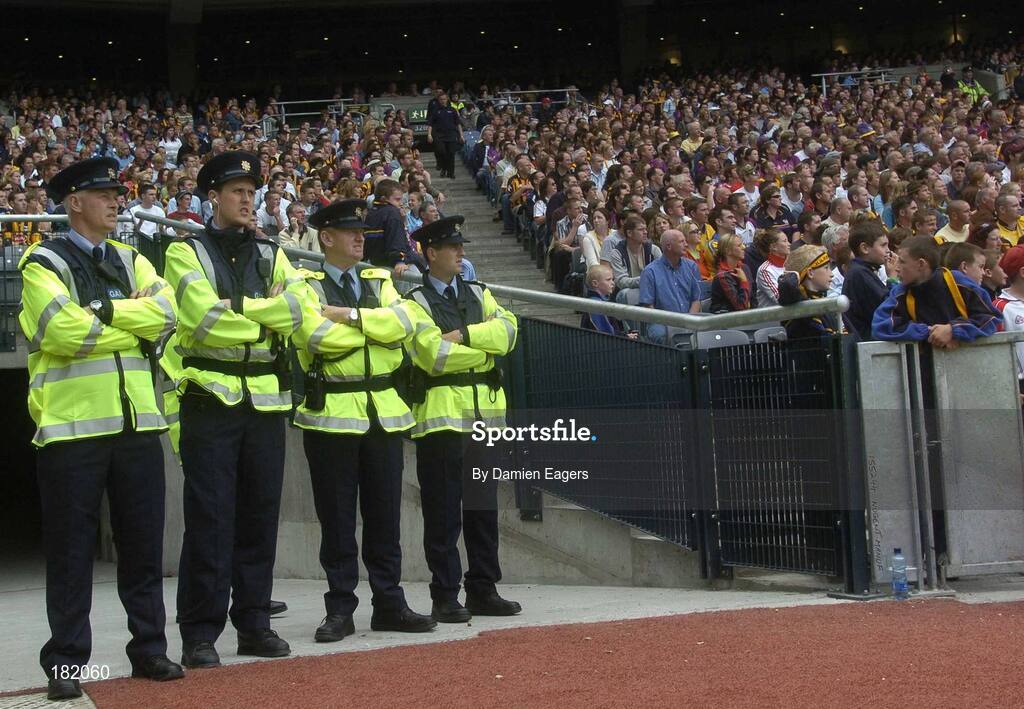 3 July 2005; Four members of the Gardai, including Gda. Eamonn Barry, left, watch the match with the crowd. Guinness Leinster Senior Hurling Championship Final, Kilkenny v Wexford, Croke Park, Dublin. Picture credit; Damien Eagers / SPORTSFILE