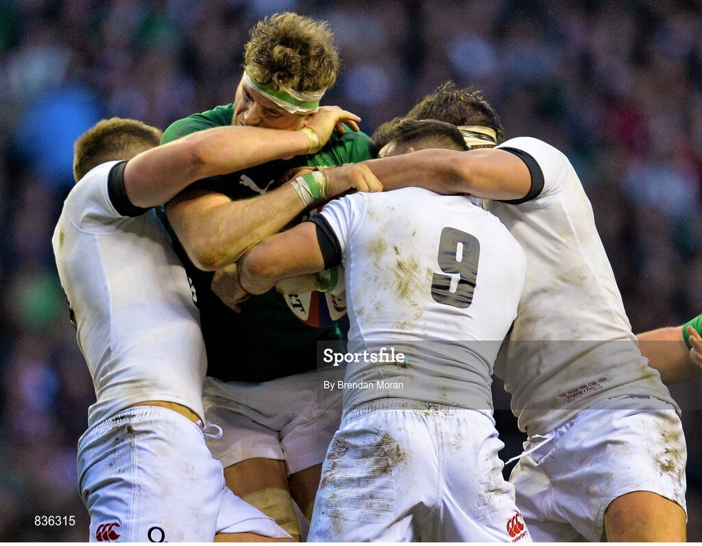 22 February 2014; Jamie Heaslip, Ireland, is tackled by Owen Farrell, left, Danny Care and Billy Vunipola, England. RBS Six Nations Rugby Championship, England v Ireland. Twickenham Stadium, Twickenham, London, England. Picture credit: Brendan Moran / SPORTSFILE