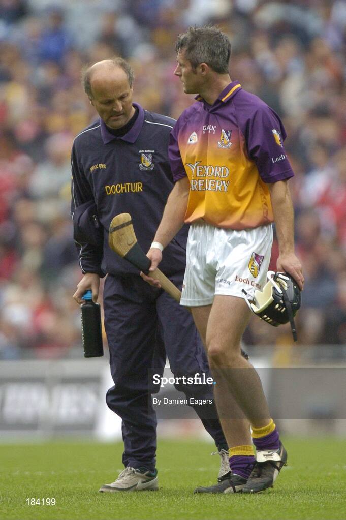 24 July 2005; Wexford's Declan Ruth walks off the pitch after picking up an injury with Wexford team doctor Stephen Bowe. Guinness All-Ireland Senior Hurling Championship Quarter-Final, Wexford v Clare, Croke Park, Dublin. Picture credit; Damien Eagers / SPORTSFILE