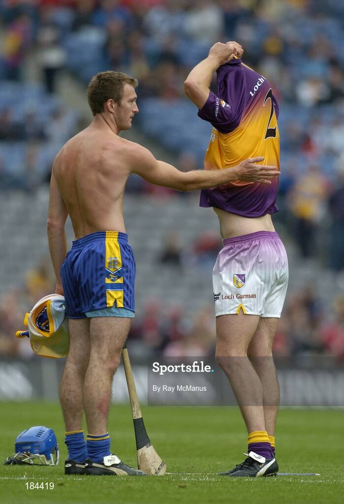 24 July 2005; Declan O'Rourke, Clare, prepares to swap jerseys with Wexford's David O'Connor. Guinness All-Ireland Senior Hurling Championship Quarter-Final, Wexford v Clare, Croke Park, Dublin. Picture credit; Ray McManus / SPORTSFILE
