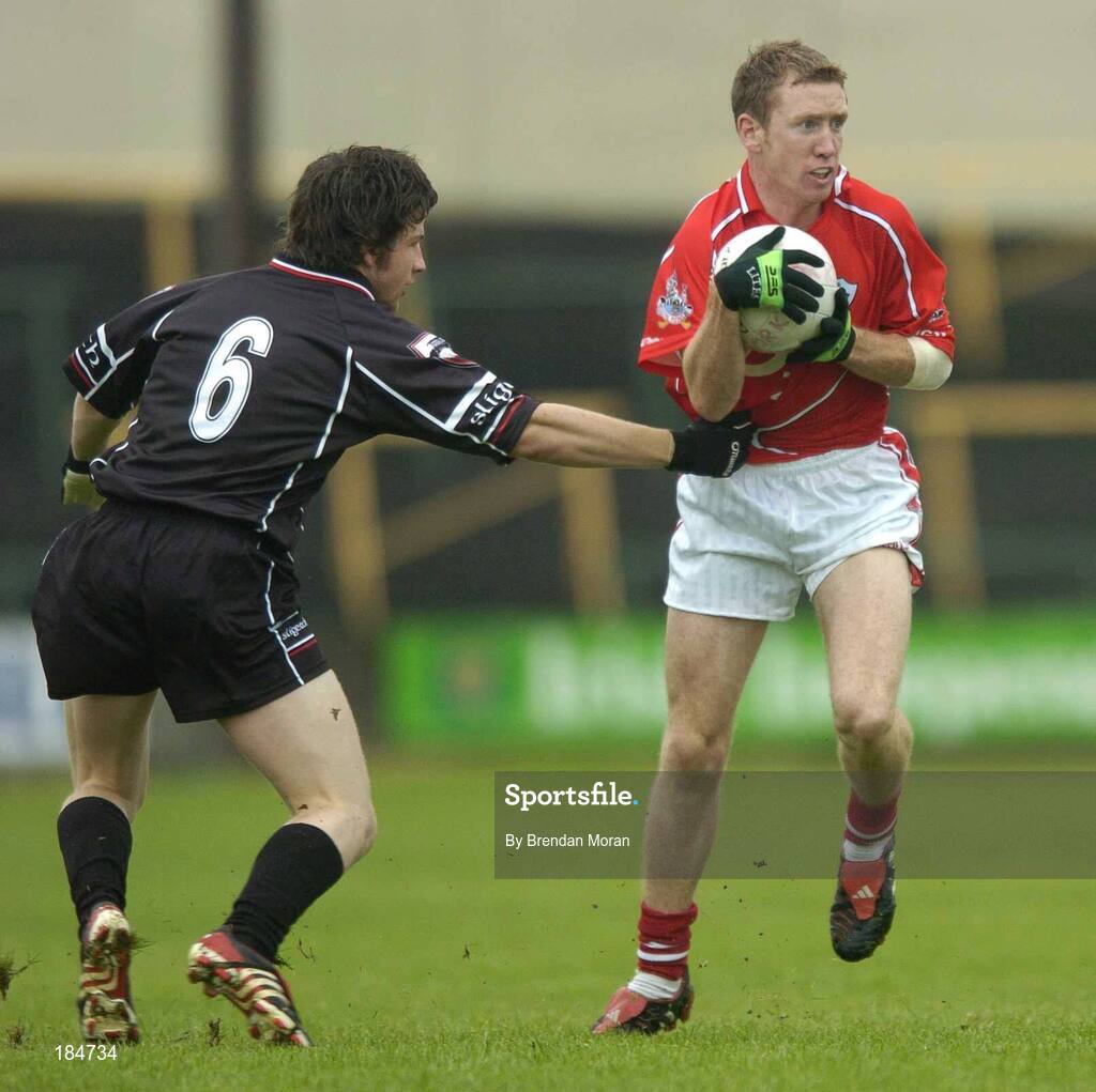 30 July 2005; Conor McCarthy, Cork, is tackled by Brendan Egan, Sligo. Bank of Ireland Football Championship qualifiers, Round 4. Cork v Sligo, O'Moore Park, Portlaoise, Co. Laois. Picture credit; Brendan Moran / SPORTSFILE