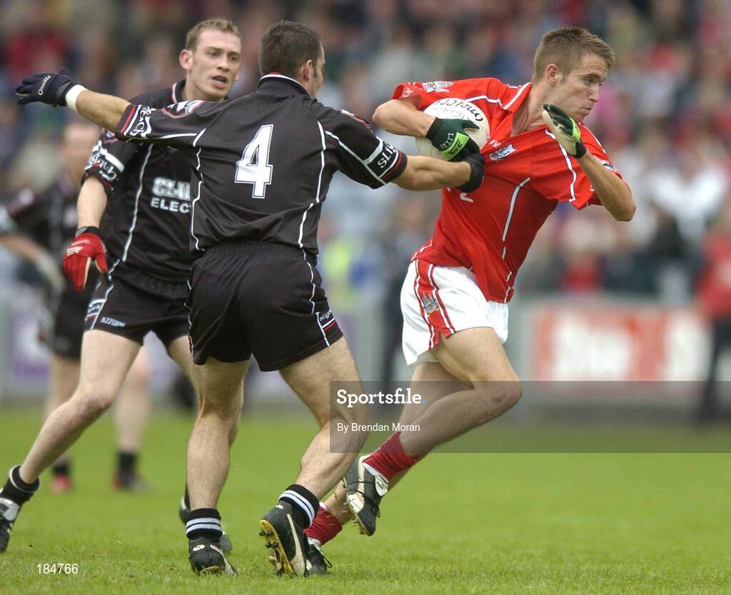 30 July 2005; Kevin McMahon, Cork, is tackled by Brendan Philips (4), Sligo. Bank of Ireland Football Championship qualifiers, Round 4. Cork v Sligo, O'Moore Park, Portlaoise, Co. Laois. Picture credit; Brendan Moran / SPORTSFILE