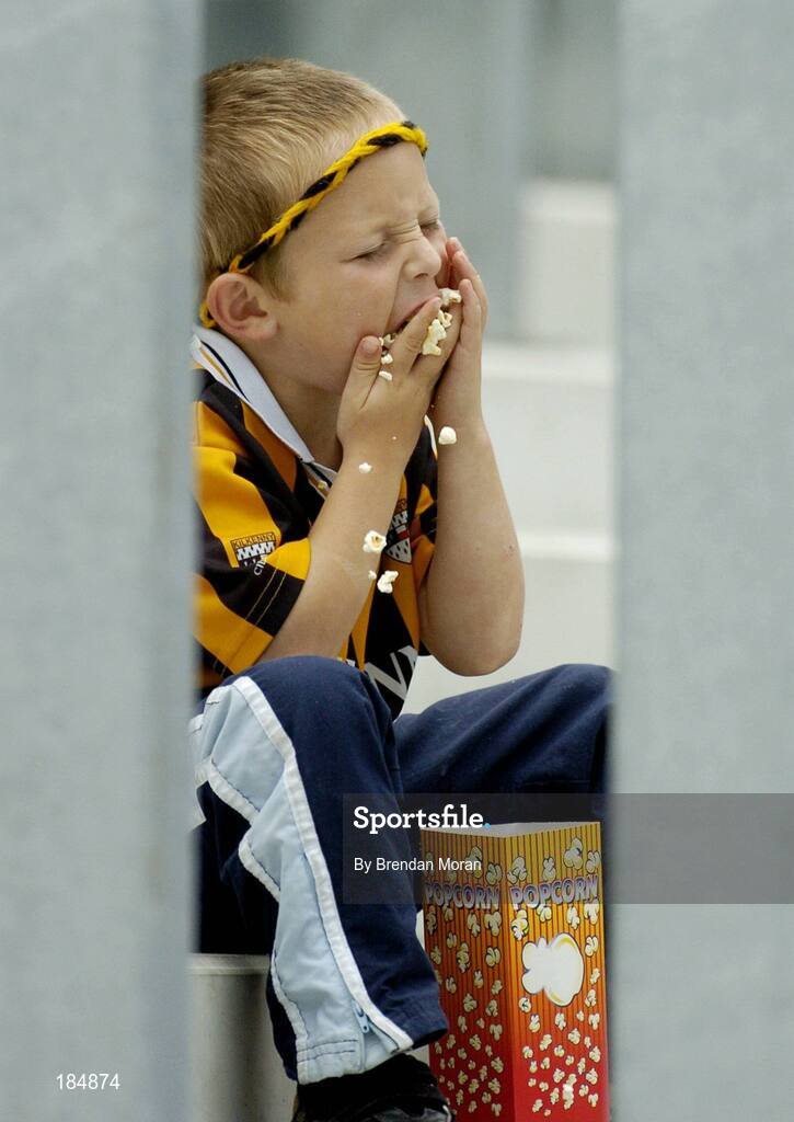 31 July 2005; Young Kilkenny supporter Jack Hawe, age 5, from Kilkenny, enjoys his popcorn during the game. Guinness All-Ireland Hurling Championship, Quarter-Final, Kilkenny v Limerick, Croke Park, Dublin. Picture credit; Brendan Moran / SPORTSFILE