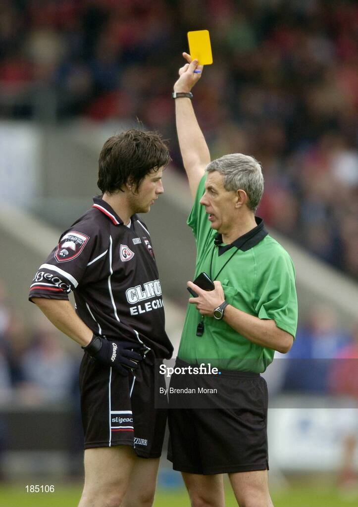 30 July 2005; Brendan Egan, Sligo, is shown a yellow card by referee Michael Hughes. Bank of Ireland Football Championship qualifiers, Round 4. Cork v Sligo, O'Moore Park, Portlaoise, Co. Laois. Picture credit; Brendan Moran / SPORTSFILE