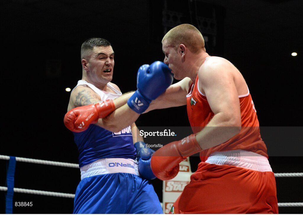 1 March 2014; Niall Kennedy, left, Gorey Boxing Club, exchanges punches with Con Sheehan, Clonmel Boxing Club, during their 91+ kg bout. National Senior Boxing Championships Semi Finals, National Stadium, Dublin. Photo by Sportsfile
