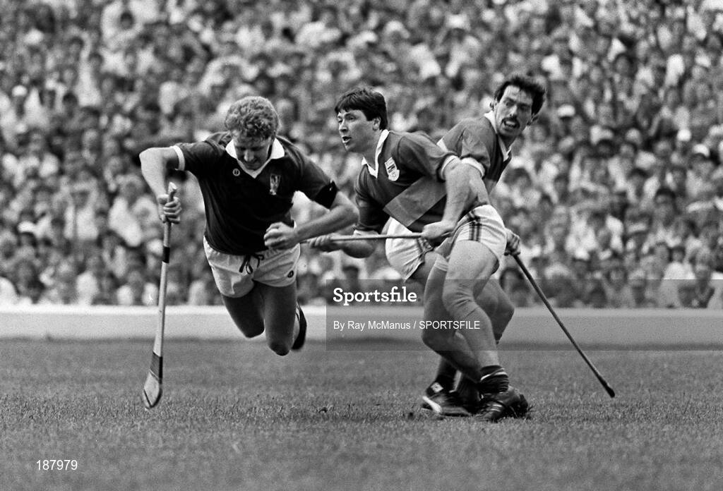 19 July 1987; Jim Cashman, Cork, is tackled by Pat Fox and team-mate Donie O'Connell, right, Tipperary. Munster Hurling Final Replay, Tipperary v Cork, Fitzgerald Stadium, Killarney, Kerry. Picture credit; Ray McManus / SPORTSFILE