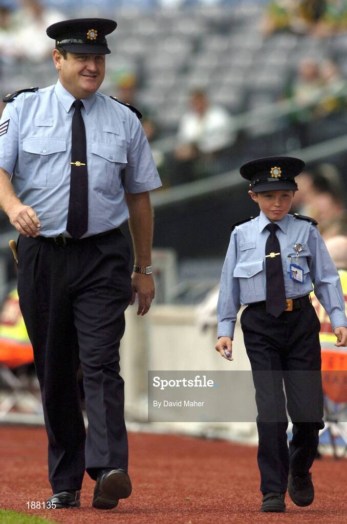 28 August 2005; David Moran, Swinford, Co. Mayo, along side Sergeant Pat Kenny, right, walk the sideline. David suffers from Leukaemia and was made a honourary member of the Gardai for a week. Bank of Ireland All-Ireland Senior Football Championship Semi-Final, Kerry v Cork, Croke Park, Dublin. Picture credit; David Maher / SPORTSFILE