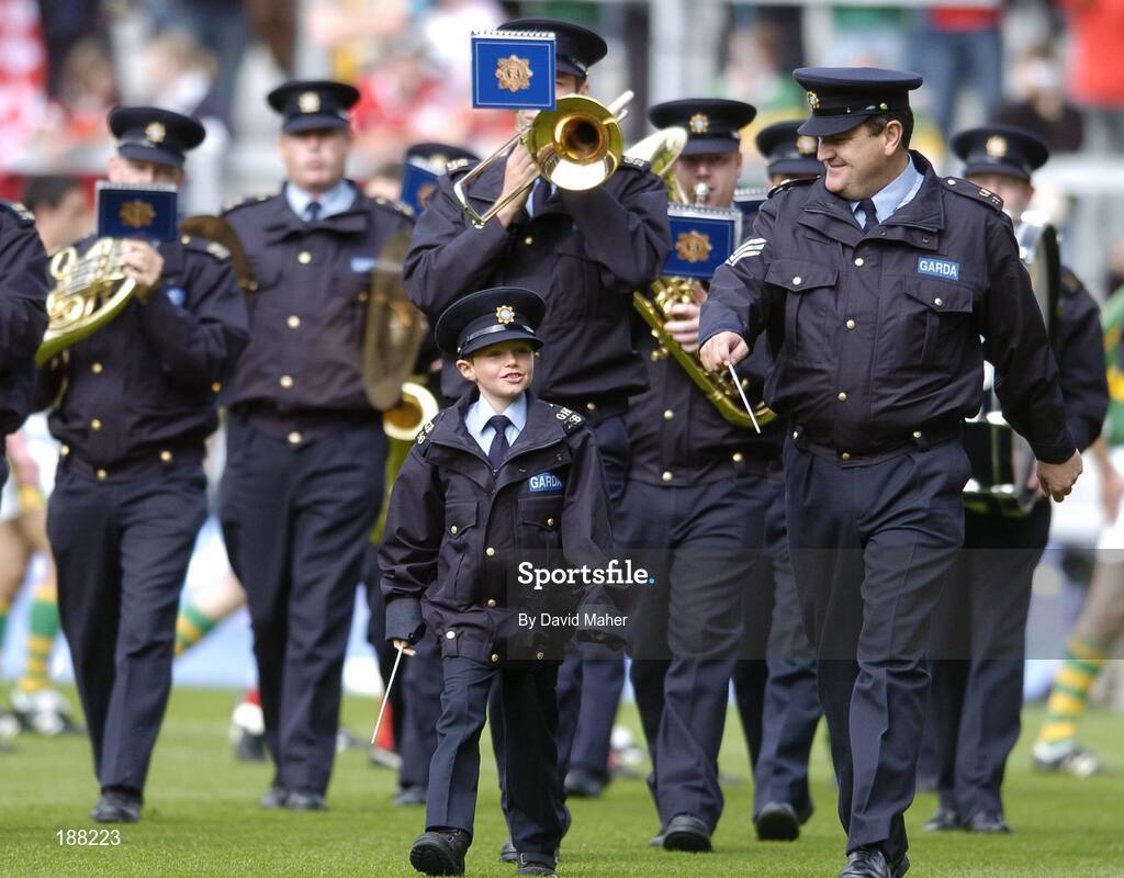28 August 2005; Seven year old David Moran, Swinford, Co. Mayo, along side Sergeant Pat Kenny, as he leads the Garda band. David who suffers from luekaemia was made a honourary member of the Garda for a week. Bank of Ireland All-Ireland Senior Football Championship Semi-Final, Kerry v Cork, Croke Park, Dublin. Picture credit; David Maher / SPORTSFILE
