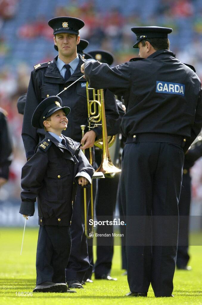 28 August 2005; Seven year old David Moran, from Swinford, Co. Mayo, with Sergeant Pat Kenny as they lead the Garda band. David suffers from leukaemia and was made an honorary member of An Garda Siochana for a week. Bank of Ireland All-Ireland Senior Football Championship Semi-Final, Kerry v Cork, Croke Park, Dublin. Picture credit; Brendan Moran / SPORTSFILE