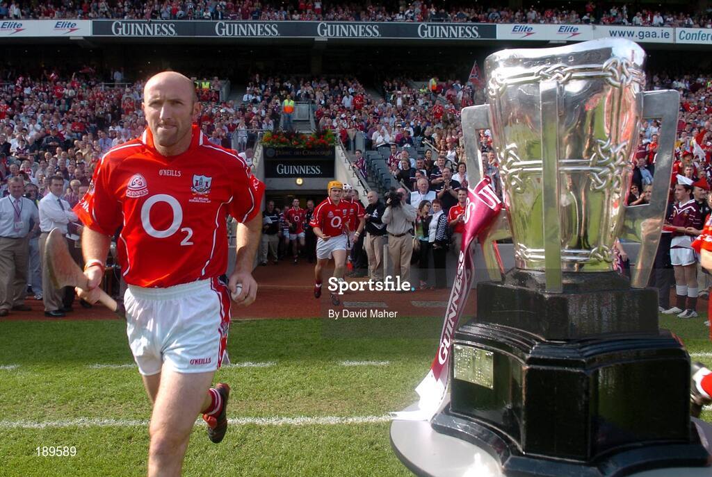11 September 2005; Brian Corcoran, Cork, runs past the Liam MacCarthy cup before the start of the game. Guinness All-Ireland Senior Hurling Championship Final, Galway v Cork, Croke Park, Dublin. Picture credit; David Maher / SPORTSFILE *** Local Caption *** Any photograph taken by SPORTSFILE during, or in connection with, the 2005 Guinness All-Ireland Hurling Final which displays GAA logos or contains an image or part of an image of any GAA intellectual property, or, which contains images of a GAA player/players in their playing uniforms, may only be used for editorial and non-advertising purposes.  Use of photographs for advertising, as posters or for purchase separately is strictly prohibited unless prior written approval has been obtained from the Gaelic Athletic Association.