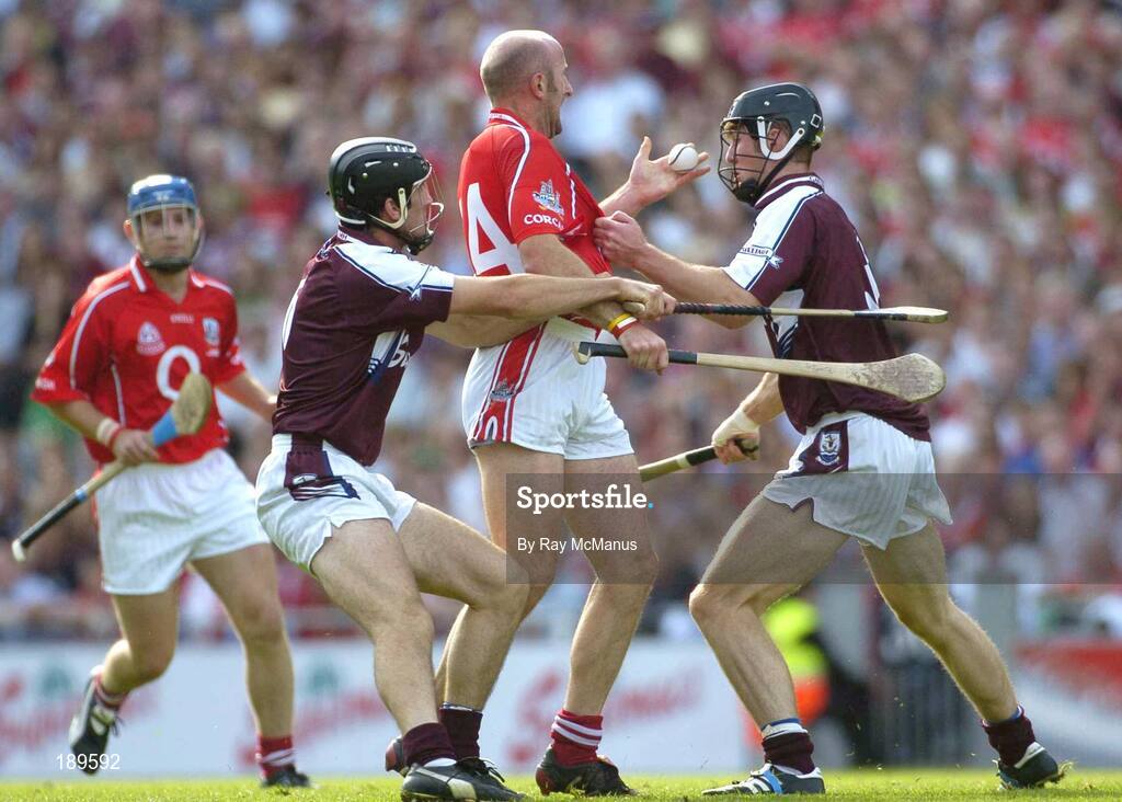 11 September 2005; Brian Corcoran, Cork, in action against Shane Kavanagh, left, and Tony Og Regan, Galway. Guinness All-Ireland Senior Hurling Championship Final, Galway v Cork, Croke Park, Dublin. Picture credit; Ray McManus / SPORTSFILE *** Local Caption *** Any photograph taken by SPORTSFILE during, or in connection with, the 2005 Guinness All-Ireland Hurling Final which displays GAA logos or contains an image or part of an image of any GAA intellectual property, or, which contains images of a GAA player/players in their playing uniforms, may only be used for editorial and non-advertising purposes.  Use of photographs for advertising, as posters or for purchase separately is strictly prohibited unless prior written approval has been obtained from the Gaelic Athletic Association.