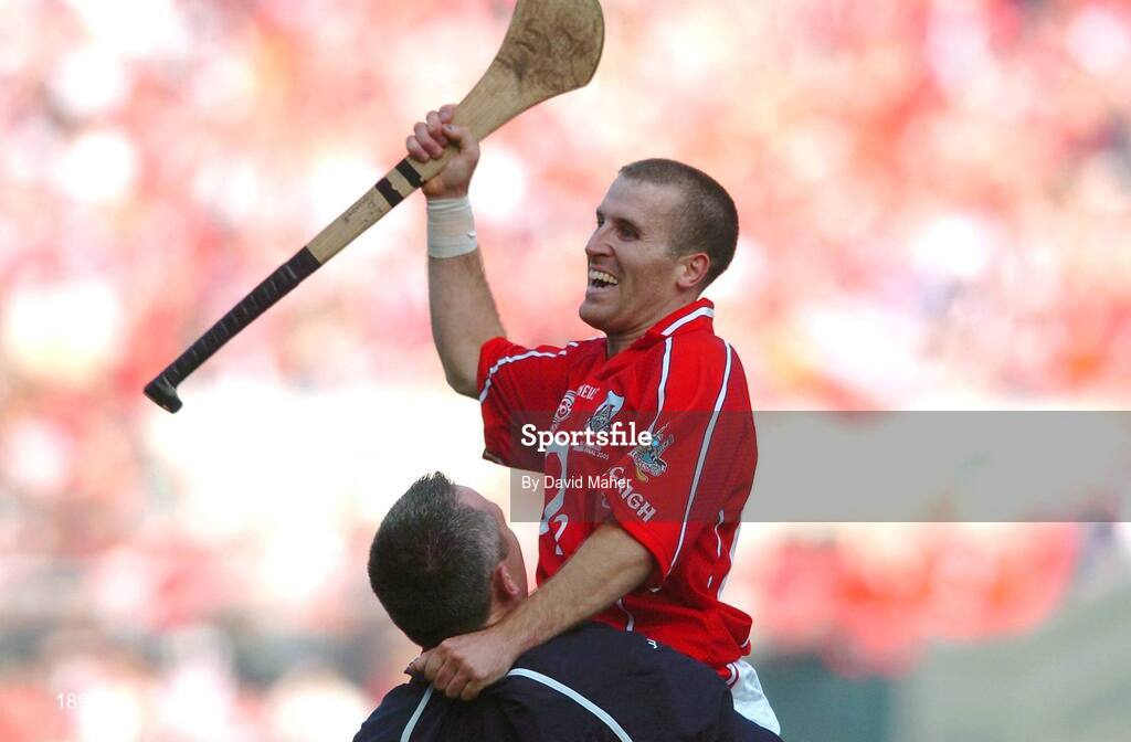 11 September 2005; Cork's goalscorer Ben O'Connor celebrates with a team official at the end of the game. Guinness All-Ireland Senior Hurling Championship Final, Galway v Cork, Croke Park, Dublin. Picture credit; David Maher / SPORTSFILE *** Local Caption *** Any photograph taken by SPORTSFILE during, or in connection with, the 2005 Guinness All-Ireland Hurling Final which displays GAA logos or contains an image or part of an image of any GAA intellectual property, or, which contains images of a GAA player/players in their playing uniforms, may only be used for editorial and non-advertising purposes.  Use of photographs for advertising, as posters or for purchase separately is strictly prohibited unless prior written approval has been obtained from the Gaelic Athletic Association.