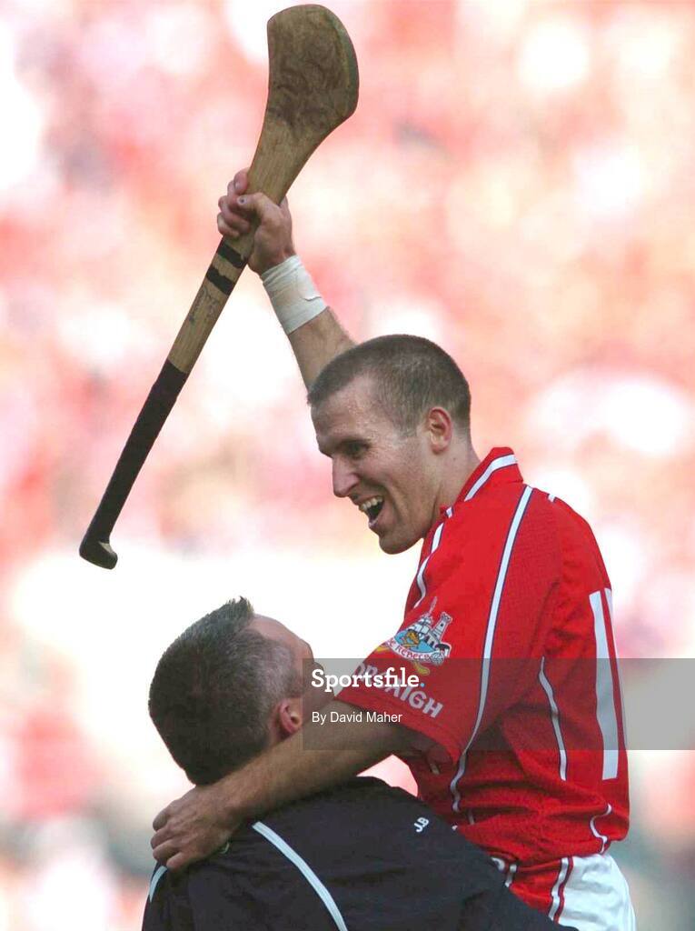 11 September 2005; Cork goalscorer Ben O'Connor celebrates with a team official at the end of the game. Guinness All-Ireland Senior Hurling Championship Final, Galway v Cork, Croke Park, Dublin. Picture credit; David Maher / SPORTSFILE *** Local Caption *** Any photograph taken by SPORTSFILE during, or in connection with, the 2005 Guinness All-Ireland Hurling Final which displays GAA logos or contains an image or part of an image of any GAA intellectual property, or, which contains images of a GAA player/players in their playing uniforms, may only be used for editorial and non-advertising purposes.  Use of photographs for advertising, as posters or for purchase separately is strictly prohibited unless prior written approval has been obtained from the Gaelic Athletic Association.
