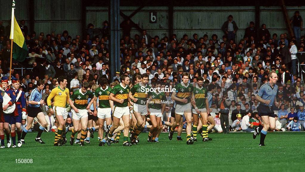 22 September 1985; Dublin's Brian Mullins, right, and the Kerry players leave the pre-match parade before the start of the All Ireland Football Championship Final match between Kerry and Dublin at Croke Park, Dublin. Photo by Ray McManus/Sportsfile