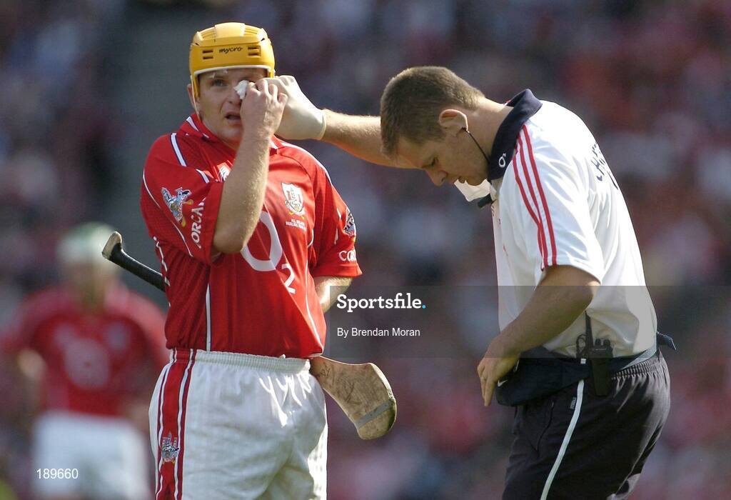 11 September 2005; Cork's Joe Deane keeps an eye on the scoreboard as he is attended to by the team physio for an eye injury. Guinness All-Ireland Senior Hurling Championship Final, Galway v Cork, Croke Park, Dublin. Picture credit; Brendan Moran / SPORTSFILE *** Local Caption *** Any photograph taken by SPORTSFILE during, or in connection with, the 2005 Guinness All-Ireland Hurling Final which displays GAA logos or contains an image or part of an image of any GAA intellectual property, or, which contains images of a GAA player/players in their playing uniforms, may only be used for editorial and non-advertising purposes.  Use of photographs for advertising, as posters or for purchase separately is strictly prohibited unless prior written approval has been obtained from the Gaelic Athletic Association.