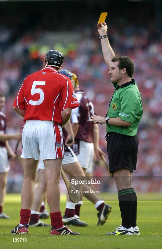11 September 2005; John Gardiner, Cork, is shown a yellow card by referee Seamus Roche. Guinness All-Ireland Senior Hurling Championship Final, Galway v Cork, Croke Park, Dublin. Picture credit; Brendan Moran / SPORTSFILE *** Local Caption *** Any photograph taken by SPORTSFILE during, or in connection with, the 2005 Guinness All-Ireland Hurling Final which displays GAA logos or contains an image or part of an image of any GAA intellectual property, or, which contains images of a GAA player/players in their playing uniforms, may only be used for editorial and non-advertising purposes.  Use of photographs for advertising, as posters or for purchase separately is strictly prohibited unless prior written approval has been obtained from the Gaelic Athletic Association.