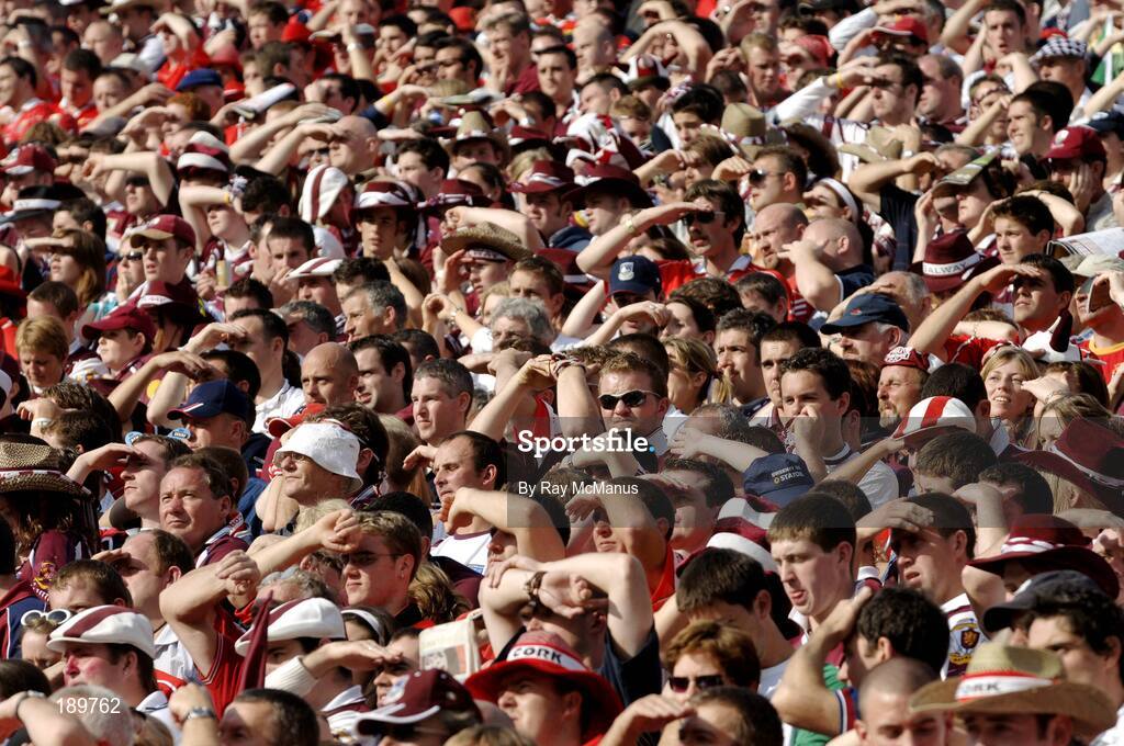 11 September 2005; Cork and Galway supporters shield their eyes from the sun during the game. Guinness All-Ireland Senior Hurling Championship Final, Galway v Cork, Croke Park, Dublin. Picture credit; Ray McManus / SPORTSFILE *** Local Caption *** Any photograph taken by SPORTSFILE during, or in connection with, the 2005 Guinness All-Ireland Hurling Final which displays GAA logos or contains an image or part of an image of any GAA intellectual property, or, which contains images of a GAA player/players in their playing uniforms, may only be used for editorial and non-advertising purposes.  Use of photographs for advertising, as posters or for purchase separately is strictly prohibited unless prior written approval has been obtained from the Gaelic Athletic Association.