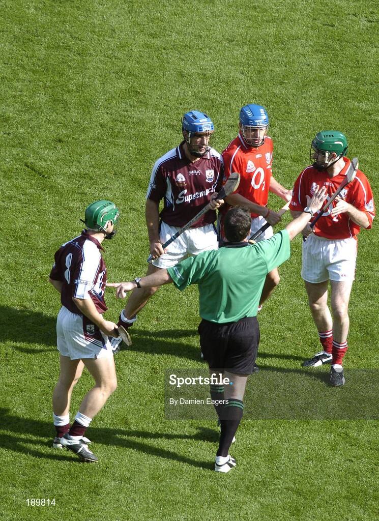 11 September 2005; Referee Seamus Roche separates Galway midfielders Fergal Healy, 8, and David Tierney, second from left, from the Cork midfield pair Tom Kenny and Jerry O'Connor, right, before the throw in. Guinness All-Ireland Senior Hurling Championship Final, Galway v Cork, Croke Park, Dublin. Picture credit; Damien Eagers / SPORTSFILE *** Local Caption *** Any photograph taken by SPORTSFILE during, or in connection with, the 2005 Guinness All-Ireland Hurling Final which displays GAA logos or contains an image or part of an image of any GAA intellectual property, or, which contains images of a GAA player/players in their playing uniforms, may only be used for editorial and non-advertising purposes.  Use of photographs for advertising, as posters or for purchase separately is strictly prohibited unless prior written approval has been obtained from the Gaelic Athletic Association.