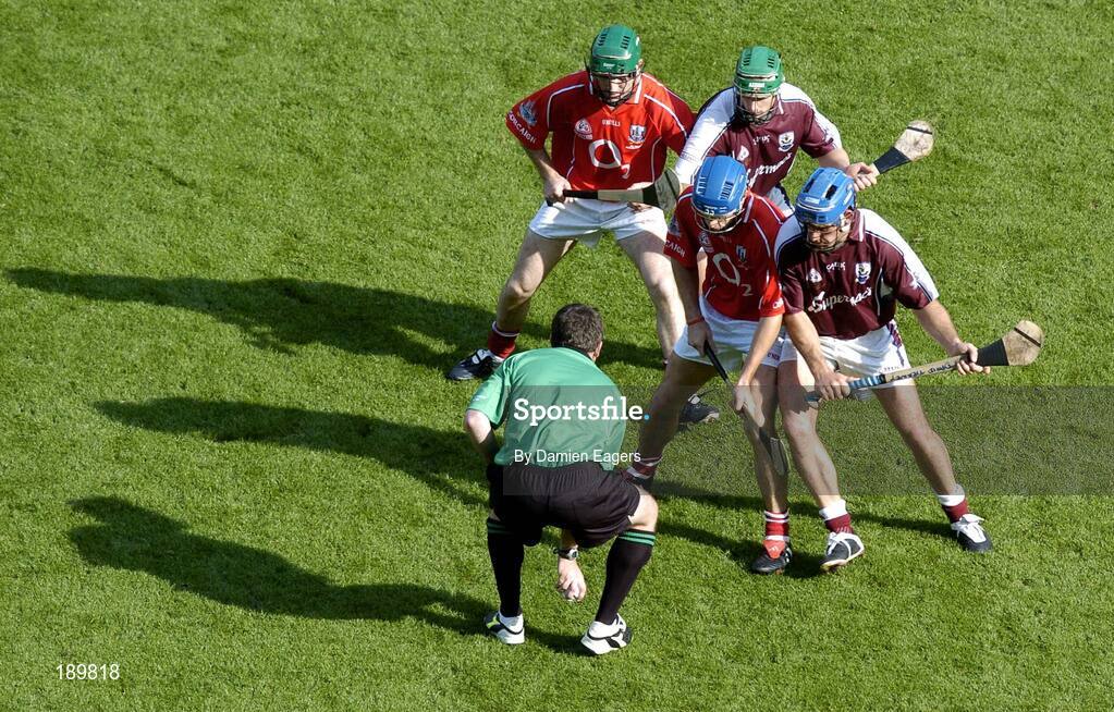 11 September 2005; Referee Seamus Roche throws the sliothar in between Galway pair David Tierney, blue helmet, and Fergal Healy and Cork pair Tom Kenny, blue helmet, and Jerry O'Connor to start the second half. Guinness All-Ireland Senior Hurling Championship Final, Galway v Cork, Croke Park, Dublin. Picture credit; Damien Eagers / SPORTSFILE *** Local Caption *** Any photograph taken by SPORTSFILE during, or in connection with, the 2005 Guinness All-Ireland Hurling Final which displays GAA logos or contains an image or part of an image of any GAA intellectual property, or, which contains images of a GAA player/players in their playing uniforms, may only be used for editorial and non-advertising purposes.  Use of photographs for advertising, as posters or for purchase separately is strictly prohibited unless prior written approval has been obtained from the Gaelic Athletic Association.