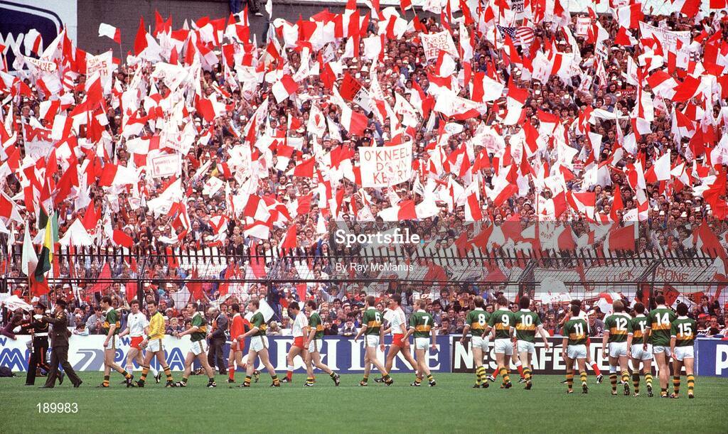 21 September 1986; The Kerry and Tyrone teams march in front of Tyrone fans in Hill 16 during the pre-match parade ahead of the All-Ireland Senior Football Championship final between Kerry and Tyrone in Croke Park, Dublin. Photo by Ray McManus/Sportsfile