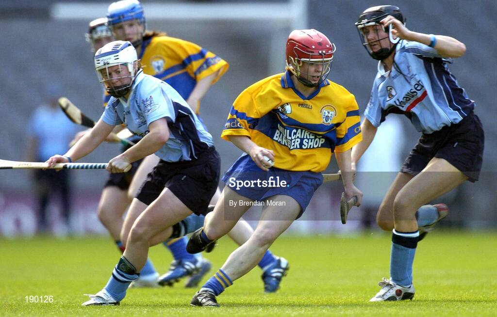 18 September 2005; Deirdre Murphy, Clare, in action against Aine Fanning, left, and Eimear Brannigan, Dublin. Dublin v Clare, All-Ireland Junior Camogie Final, Croke Park, Dublin. Picture credit; Brendan Moran / SPORTSFILE *** Local Caption *** Any photograph taken by SPORTSFILE during, or in connection with, the 2005 Guinness All-Ireland Hurling Final which displays GAA logos or contains an image or part of an image of any GAA intellectual property, or, which contains images of a GAA player/players in their playing uniforms, may only be used for editorial and non-advertising purposes.  Use of photographs for advertising, as posters or for purchase separately is strictly prohibited unless prior written approval has been obtained from the Gaelic Athletic Association.