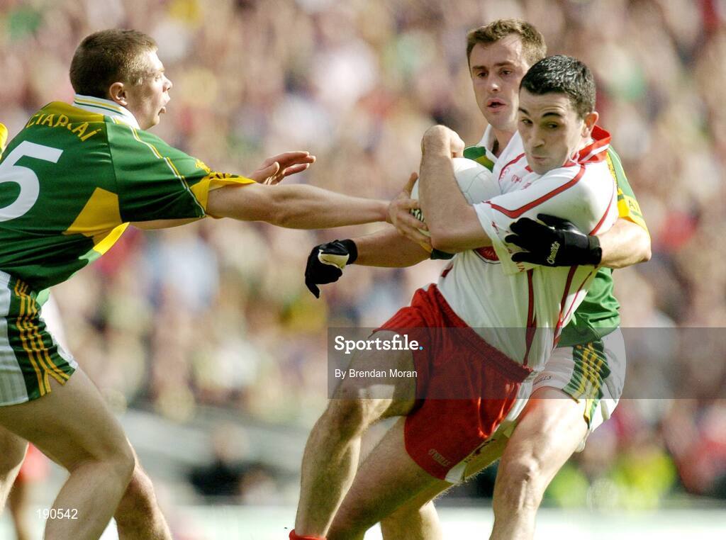 25 September 2005; Ryan Mellon, Tyrone, in action against Tomas O Se, left, and William Kirby, Kerry. Bank of Ireland All-Ireland Senior Football Championship Final, Kerry v Tyrone, Croke Park, Dublin. Picture credit; Brendan Moran / SPORTSFILE *** Local Caption *** Any photograph taken by SPORTSFILE during, or in connection with, the 2005 Bank of Ireland All-Ireland Senior Football Final which displays GAA logos or contains an image or part of an image of any GAA intellectual property, or, which contains images of a GAA player/players in their playing uniforms, may only be used for editorial and non-advertising purposes.  Use of photographs for advertising, as posters or for purchase separately is strictly prohibited unless prior written approval has been obtained from the Gaelic Athletic Association.