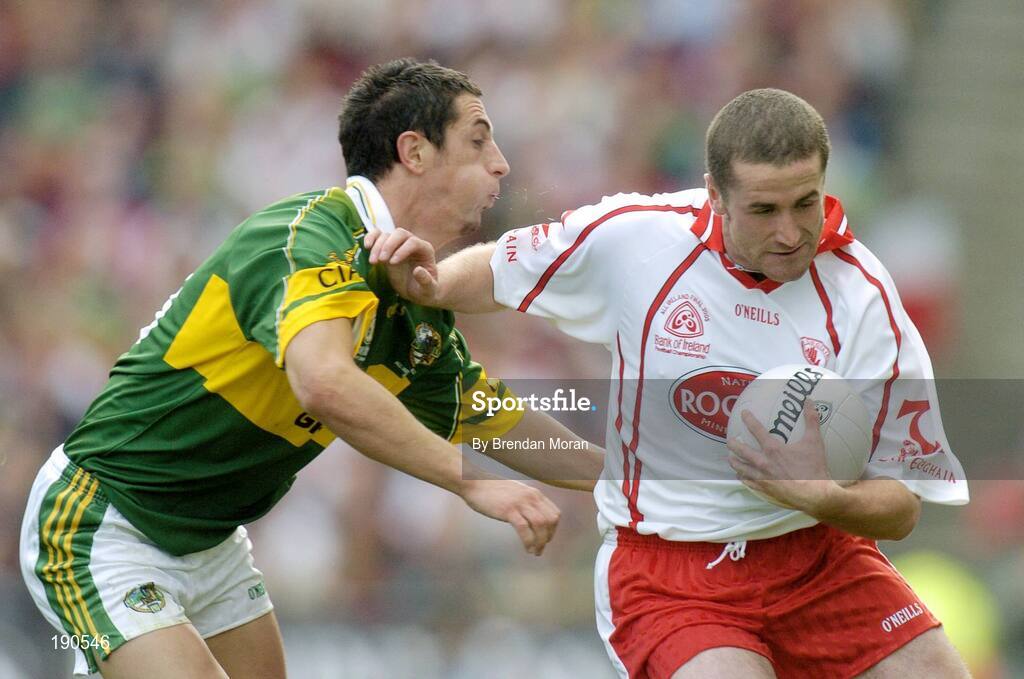 25 September 2005; Stephen O'Neill, Tyrone, holds off the challenge of Paul Galvin, Kerry. Bank of Ireland All-Ireland Senior Football Championship Final, Kerry v Tyrone, Croke Park, Dublin. Picture credit; Brendan Moran / SPORTSFILE *** Local Caption *** Any photograph taken by SPORTSFILE during, or in connection with, the 2005 Bank of Ireland All-Ireland Senior Football Final which displays GAA logos or contains an image or part of an image of any GAA intellectual property, or, which contains images of a GAA player/players in their playing uniforms, may only be used for editorial and non-advertising purposes.  Use of photographs for advertising, as posters or for purchase separately is strictly prohibited unless prior written approval has been obtained from the Gaelic Athletic Association.