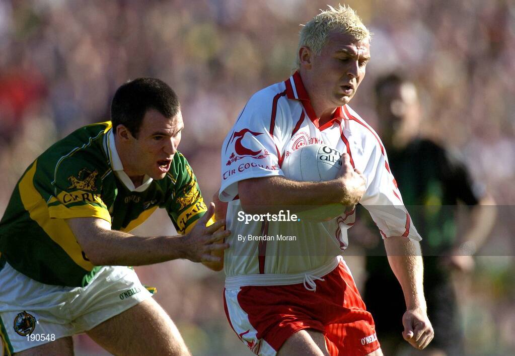 25 September 2005; Eoin Mulligan, Tyrone, in action against Michael McCarthy, Kerry. Bank of Ireland All-Ireland Senior Football Championship Final, Kerry v Tyrone, Croke Park, Dublin. Picture credit; Brendan Moran / SPORTSFILE *** Local Caption *** Any photograph taken by SPORTSFILE during, or in connection with, the 2005 Bank of Ireland All-Ireland Senior Football Final which displays GAA logos or contains an image or part of an image of any GAA intellectual property, or, which contains images of a GAA player/players in their playing uniforms, may only be used for editorial and non-advertising purposes.  Use of photographs for advertising, as posters or for purchase separately is strictly prohibited unless prior written approval has been obtained from the Gaelic Athletic Association.