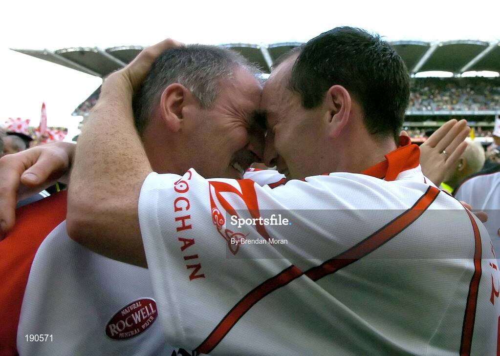 25 September 2005; Tyrone manager Mickey Harte, left, celebrates with captain Brian Dooher after the game. Bank of Ireland All-Ireland Senior Football Championship Final, Kerry v Tyrone, Croke Park, Dublin. Picture credit; Brendan Moran / SPORTSFILE *** Local Caption *** Any photograph taken by SPORTSFILE during, or in connection with, the 2005 Bank of Ireland All-Ireland Senior Football Final which displays GAA logos or contains an image or part of an image of any GAA intellectual property, or, which contains images of a GAA player/players in their playing uniforms, may only be used for editorial and non-advertising purposes.  Use of photographs for advertising, as posters or for purchase separately is strictly prohibited unless prior written approval has been obtained from the Gaelic Athletic Association.