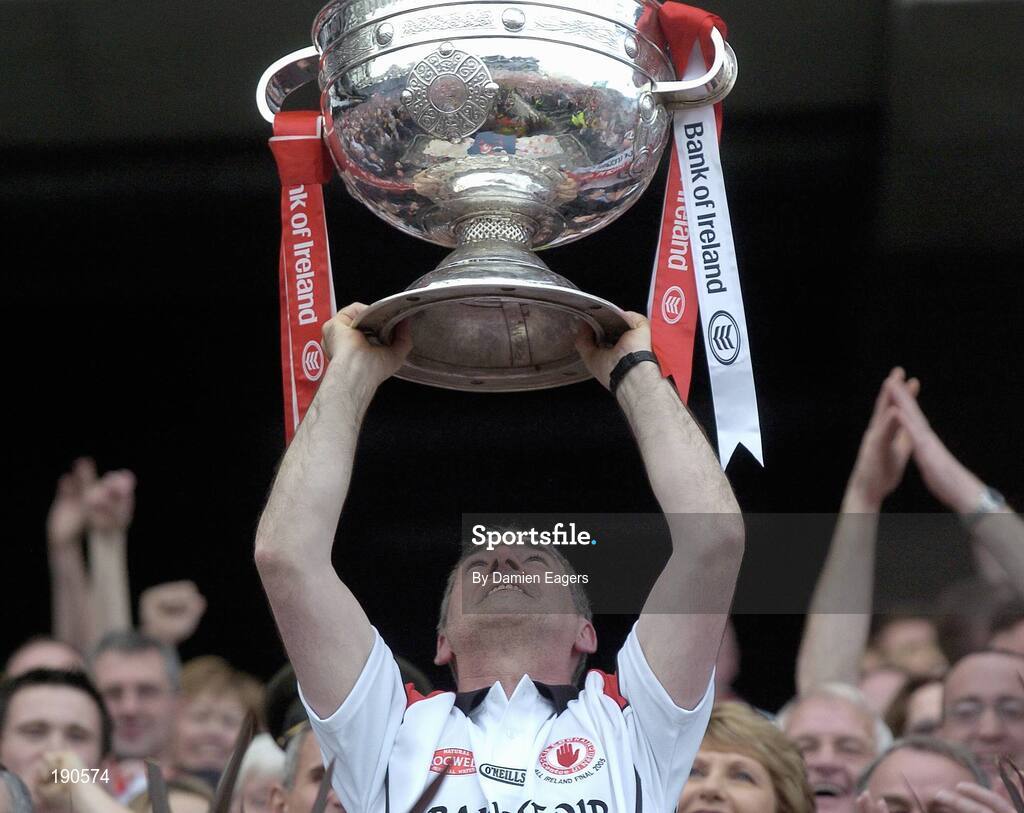 25 September 2005; Tyrone manager Mickey Harte lifts the Sam Maguire Cup, Bank of Ireland All-Ireland Senior Football Championship Final, Kerry v Tyrone, Croke Park, Dublin. Picture credit; Damien Eagers/ SPORTSFILE *** Local Caption *** Any photograph taken by SPORTSFILE during, or in connection with, the 2005 Bank of Ireland All-Ireland Senior Football Final which displays GAA logos or contains an image or part of an image of any GAA intellectual property, or, which contains images of a GAA player/players in their playing uniforms, may only be used for editorial and non-advertising purposes.  Use of photographs for advertising, as posters or for purchase separately is strictly prohibited unless prior written approval has been obtained from the Gaelic Athletic Association.