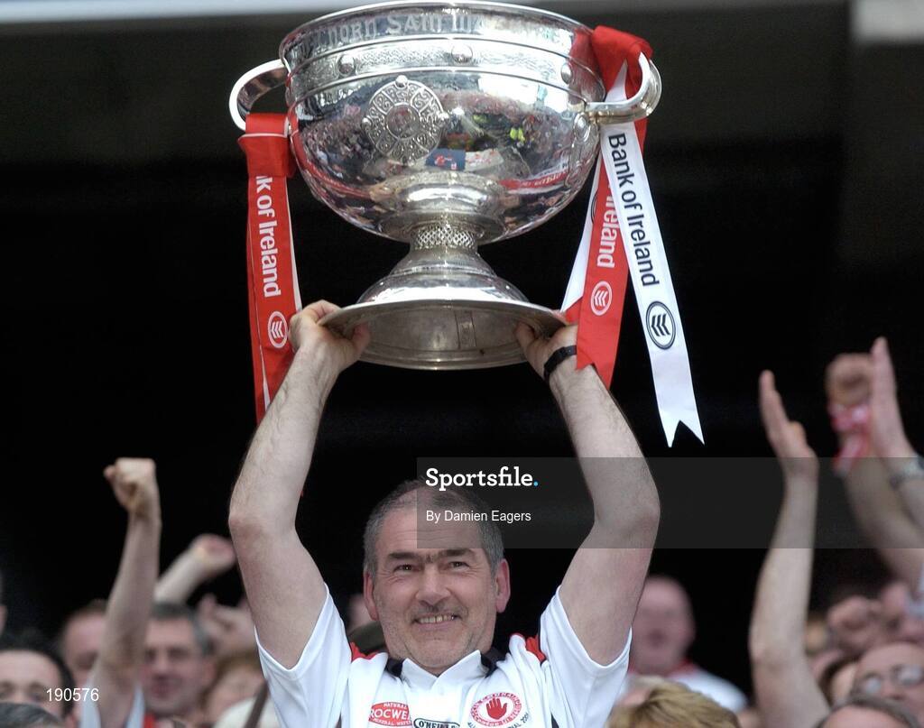 25 September 2005; Tyrone manager Mickey Harte lifts the Sam Maguire Cup. Bank of Ireland All-Ireland Senior Football Championship Final, Kerry v Tyrone, Croke Park, Dublin. Picture credit; Damien Eagers/ SPORTSFILE *** Local Caption *** Any photograph taken by SPORTSFILE during, or in connection with, the 2005 Bank of Ireland All-Ireland Senior Football Final which displays GAA logos or contains an image or part of an image of any GAA intellectual property, or, which contains images of a GAA player/players in their playing uniforms, may only be used for editorial and non-advertising purposes.  Use of photographs for advertising, as posters or for purchase separately is strictly prohibited unless prior written approval has been obtained from the Gaelic Athletic Association.