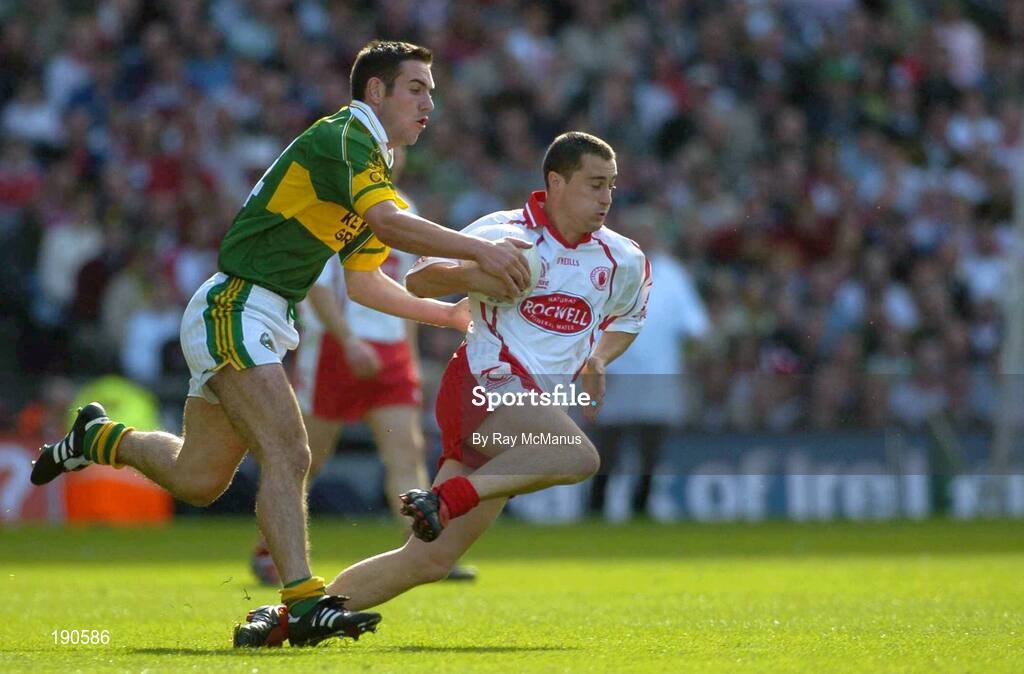 25 September 2005; Brian McGuigan, Tyrone, in action against Eoin Brosnan, Kerry. Bank of Ireland All-Ireland Senior Football Championship Final, Kerry v Tyrone, Croke Park, Dublin. Picture credit; Ray McManus / SPORTSFILE *** Local Caption *** Any photograph taken by SPORTSFILE during, or in connection with, the 2005 Bank of Ireland All-Ireland Senior Football Final which displays GAA logos or contains an image or part of an image of any GAA intellectual property, or, which contains images of a GAA player/players in their playing uniforms, may only be used for editorial and non-advertising purposes.  Use of photographs for advertising, as posters or for purchase separately is strictly prohibited unless prior written approval has been obtained from the Gaelic Athletic Association.