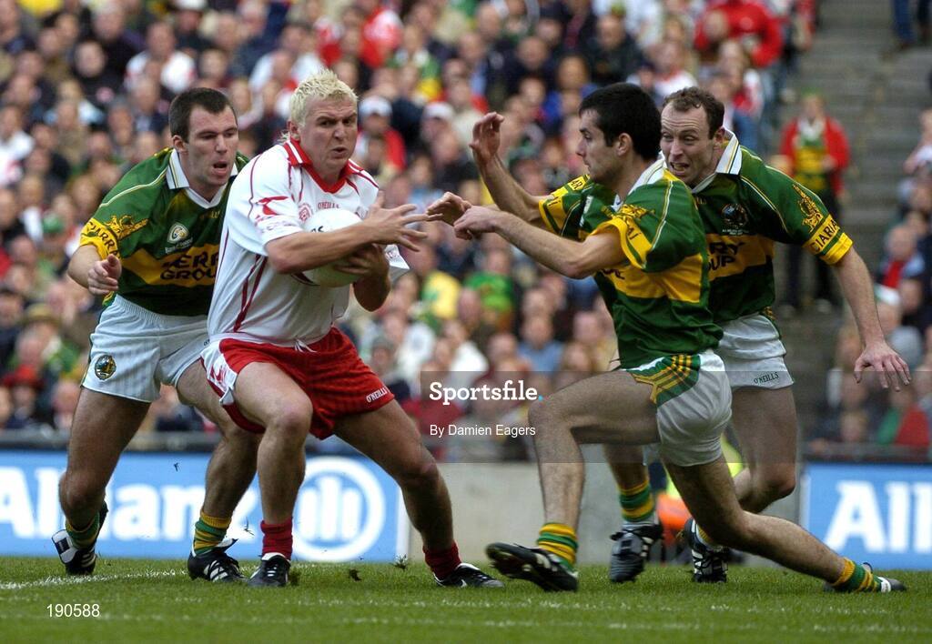 25 September 2005; Eoin Mulligan, Tyrone, in action against Kerry players from left Mike McCarthy, Tom O'Sullivan and Seamus Moynihan, Bank of Ireland All-Ireland Senior Football Championship Final. Kerry v Tyrone, Croke Park, Dublin. Picture credit; Damien Eagers/ SPORTSFILE *** Local Caption *** Any photograph taken by SPORTSFILE during, or in connection with, the 2005 Bank of Ireland All-Ireland Senior Football Final which displays GAA logos or contains an image or part of an image of any GAA intellectual property, or, which contains images of a GAA player/players in their playing uniforms, may only be used for editorial and non-advertising purposes.  Use of photographs for advertising, as posters or for purchase separately is strictly prohibited unless prior written approval has been obtained from the Gaelic Athletic Association.