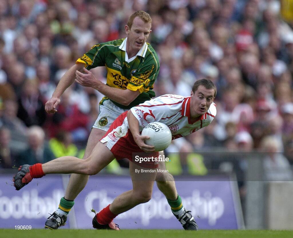 25 September 2005; Brian McGuigan, Tyrone, in action against Liam Hassett, Kerry. Bank of Ireland All-Ireland Senior Football Championship Final, Kerry v Tyrone, Croke Park, Dublin. Picture credit; Brendan Moran / SPORTSFILE *** Local Caption *** Any photograph taken by SPORTSFILE during, or in connection with, the 2005 Bank of Ireland All-Ireland Senior Football Final which displays GAA logos or contains an image or part of an image of any GAA intellectual property, or, which contains images of a GAA player/players in their playing uniforms, may only be used for editorial and non-advertising purposes.  Use of photographs for advertising, as posters or for purchase separately is strictly prohibited unless prior written approval has been obtained from the Gaelic Athletic Association.