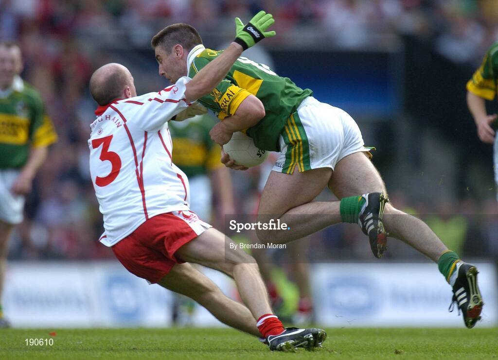 25 September 2005; Darragh O Se, Kerry, is tackled by Peter Canavan, Tyrone. Bank of Ireland All-Ireland Senior Football Championship Final, Kerry v Tyrone, Croke Park, Dublin. Picture credit; Brendan Moran / SPORTSFILE *** Local Caption *** Any photograph taken by SPORTSFILE during, or in connection with, the 2005 Bank of Ireland All-Ireland Senior Football Final which displays GAA logos or contains an image or part of an image of any GAA intellectual property, or, which contains images of a GAA player/players in their playing uniforms, may only be used for editorial and non-advertising purposes.  Use of photographs for advertising, as posters or for purchase separately is strictly prohibited unless prior written approval has been obtained from the Gaelic Athletic Association.