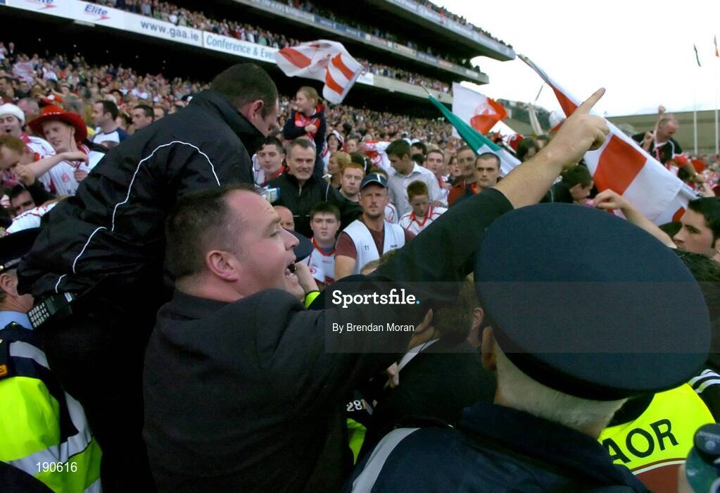 25 September 2005; Security personnel and Gardai urge the crowd to keep back from the presentation area after the game. Bank of Ireland All-Ireland Senior Football Championship Final, Kerry v Tyrone, Croke Park, Dublin. Picture credit; Brendan Moran / SPORTSFILE *** Local Caption *** Any photograph taken by SPORTSFILE during, or in connection with, the 2005 Bank of Ireland All-Ireland Senior Football Final which displays GAA logos or contains an image or part of an image of any GAA intellectual property, or, which contains images of a GAA player/players in their playing uniforms, may only be used for editorial and non-advertising purposes.  Use of photographs for advertising, as posters or for purchase separately is strictly prohibited unless prior written approval has been obtained from the Gaelic Athletic Association.