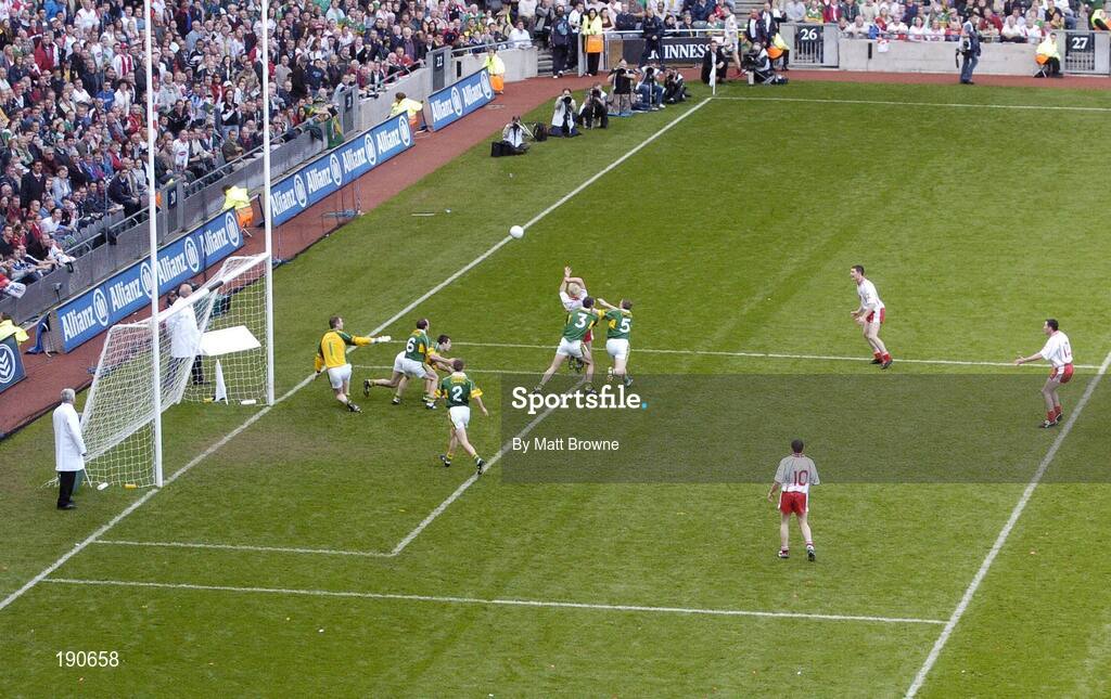 25 September 2005; Eoin, Mulligan, Tyrone, fists a point under pressure from Michael McCarthy (3) and Tomas O Se (5), Kerry. Bank of Ireland All-Ireland Senior Football Championship Final, Kerry v Tyrone, Croke Park, Dublin. Picture credit; Matt Browne / SPORTSFILE *** Local Caption *** Any photograph taken by SPORTSFILE during, or in connection with, the 2005 Bank of Ireland All-Ireland Senior Football Final which displays GAA logos or contains an image or part of an image of any GAA intellectual property, or, which contains images of a GAA player/players in their playing uniforms, may only be used for editorial and non-advertising purposes.  Use of photographs for advertising, as posters or for purchase separately is strictly prohibited unless prior written approval has been obtained from the Gaelic Athletic Association.